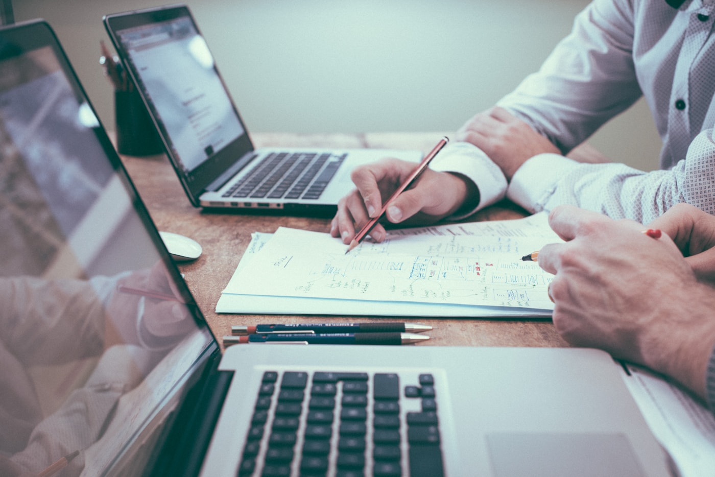 Payroll records, reports, and planning paperwork on a desk